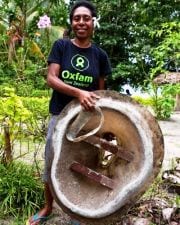 Pauline holds a typical toilet used by Oxfam in PNG and Bougainville. Photo: Tom Greenwood/Oxfam