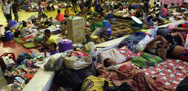 Evacuees shelter from Typhoon Haiyan in a gymnasium