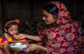 woman feeding her child