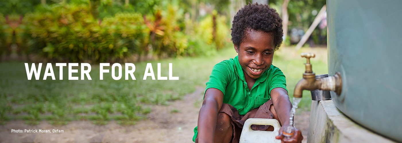 A young child fills up a water container