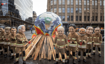 Image of people dressed as world leaders around a large earth above matches