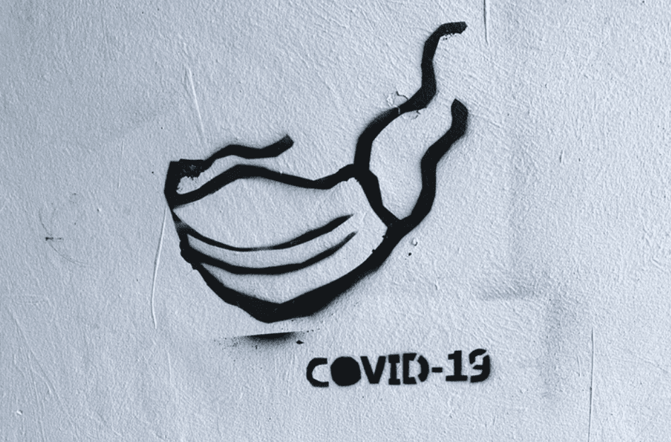 Image of a stencil of a mask with test 'COVID-19'
