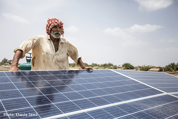 A man holds a solar panel