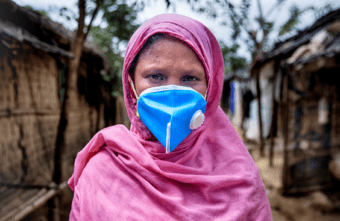 Woman wearing a blue mask, dressed in pink