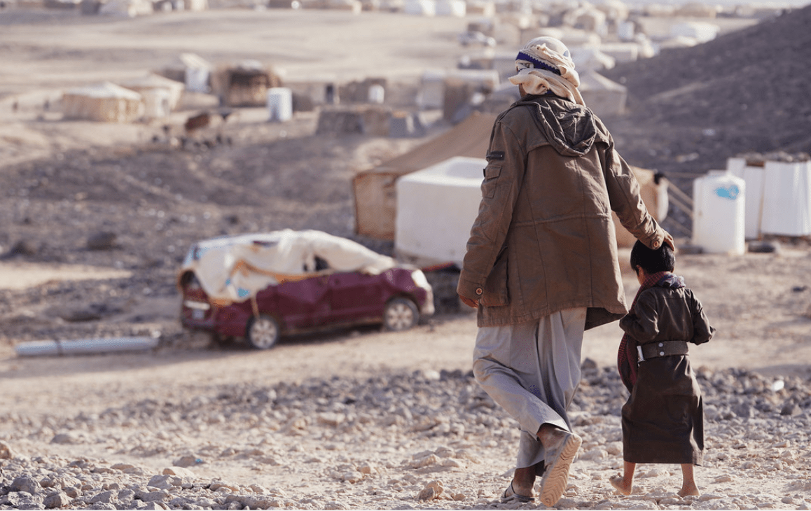 A man and young child in Yemen walk together