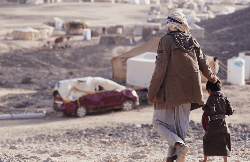 Image of a father and his child walking side by side