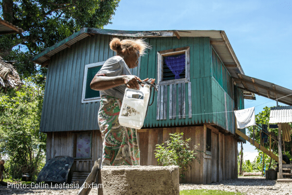 A woman holds a container of water