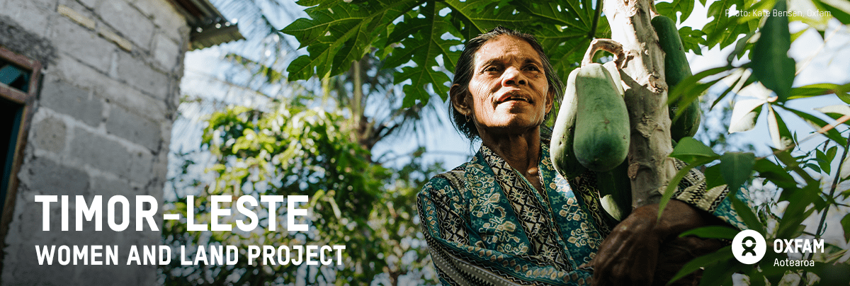 A woman stares above near her garden, with text 'Timor-leste women and land project'