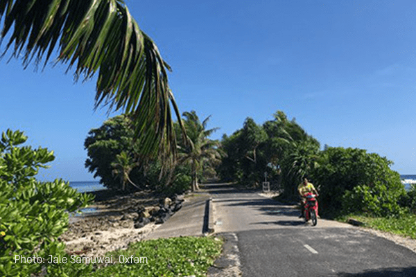 A person rides their bike down the street