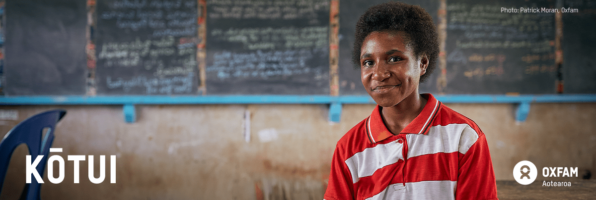 Image of a girl wearing a red shirt, smiling at the camera with text 'Kōtui'