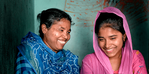 Two women laugh together