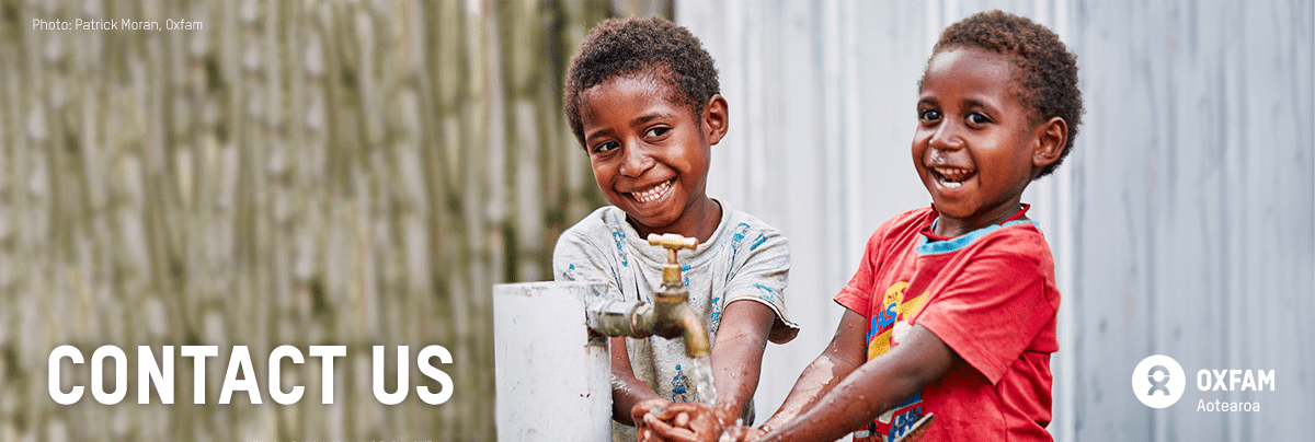 Two boys wash their hands with text 'contact us'