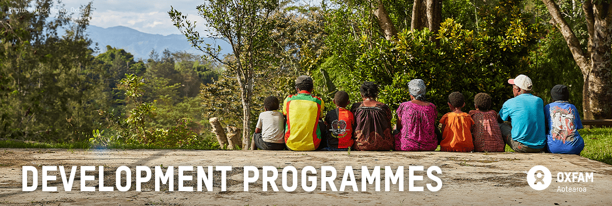 A group of people sit together with text 'development programmes'