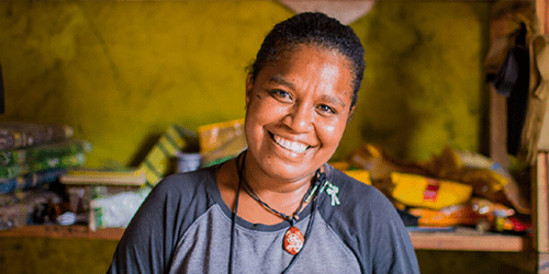 A woman smiles in her shop