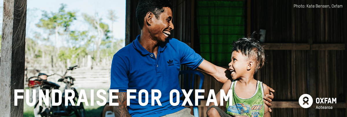 A father and child sit together with text 'fundraise for Oxfam'