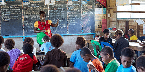 A teacher speaks to her class