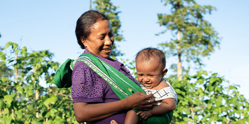 A woman holds a young child