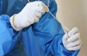 A health worker holds a Covid test swab