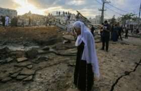 A woman in Gaza stands near a street