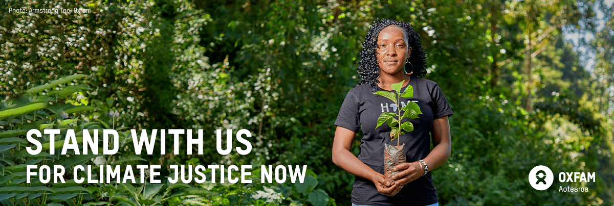 Elizabeth holds a plant with text 'stand with us for climate justice now'