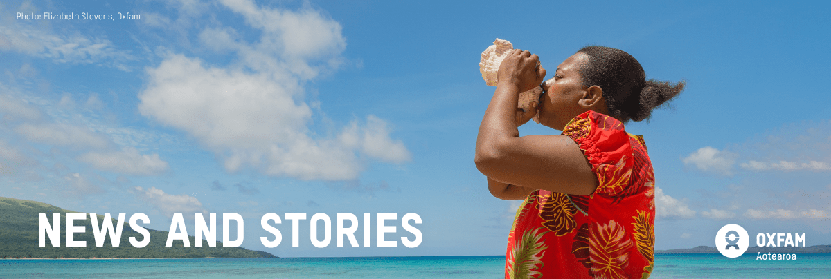 A woman blows a conch shell