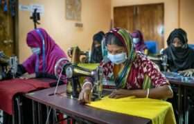 A woman works at her sewing machine