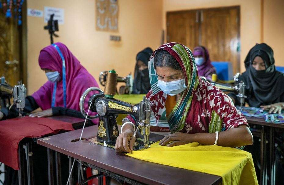 A woman works at her sewing machine