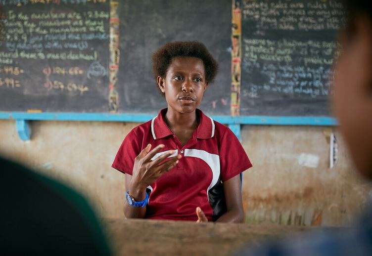 A girl sits in class