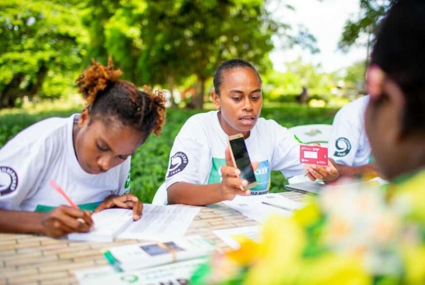 Oxfam staff work at a table