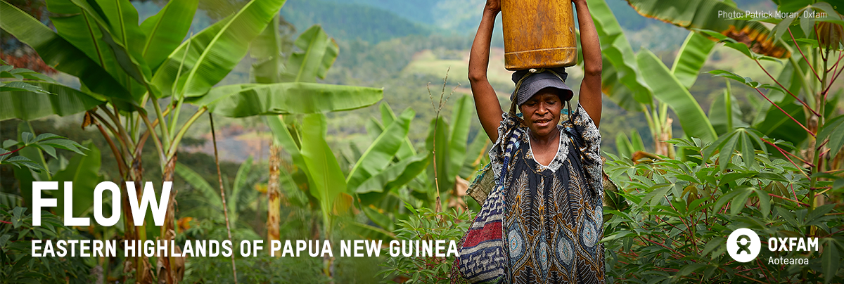 A woman carries a water bucket