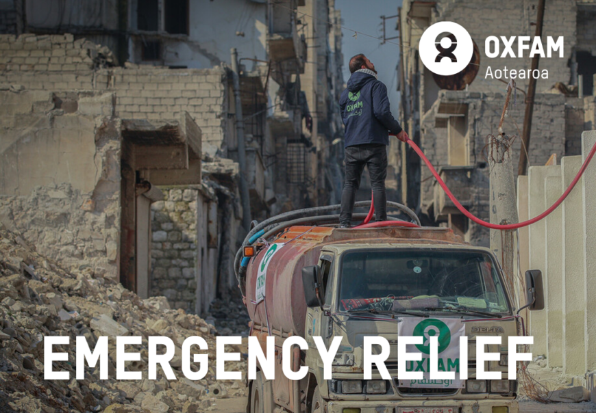 A man standing atop a truck delivering water; text - emergency relief