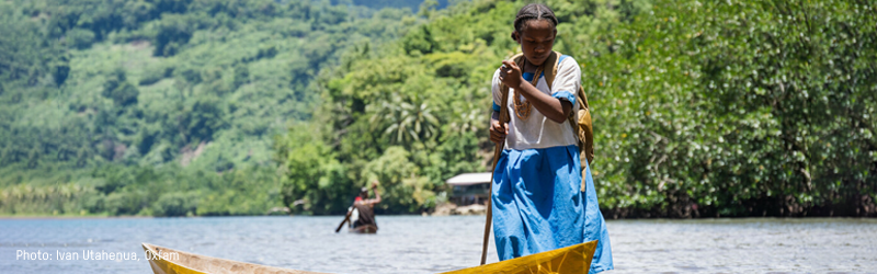 Girl standing with a canoe