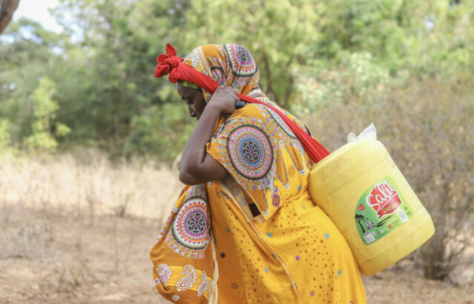 A woman carrying water