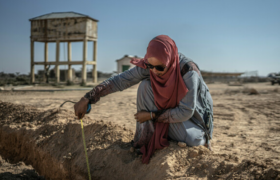 Woman measuring in a drought area