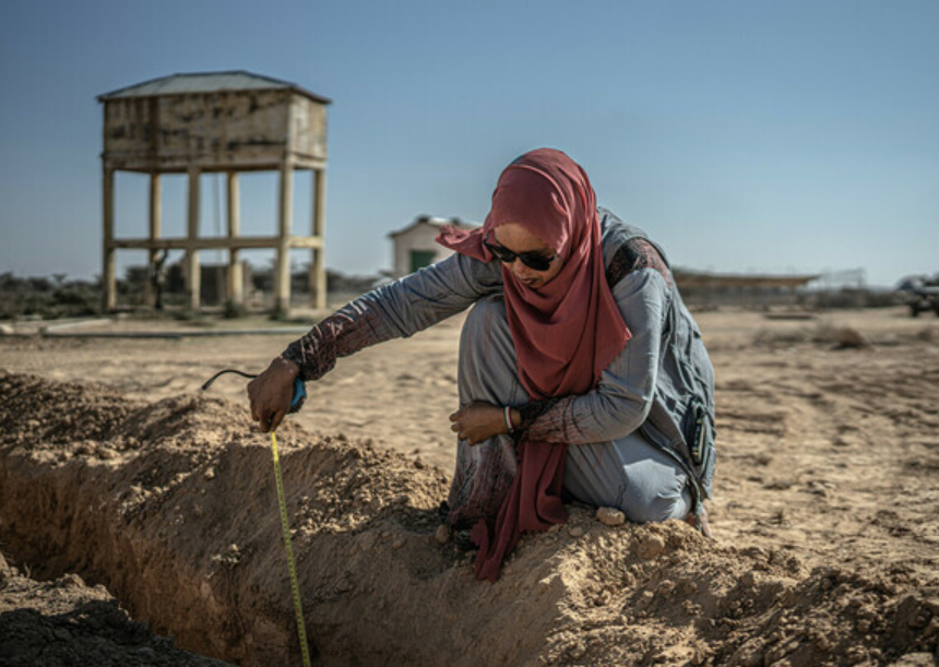 Woman measuring in a drought area