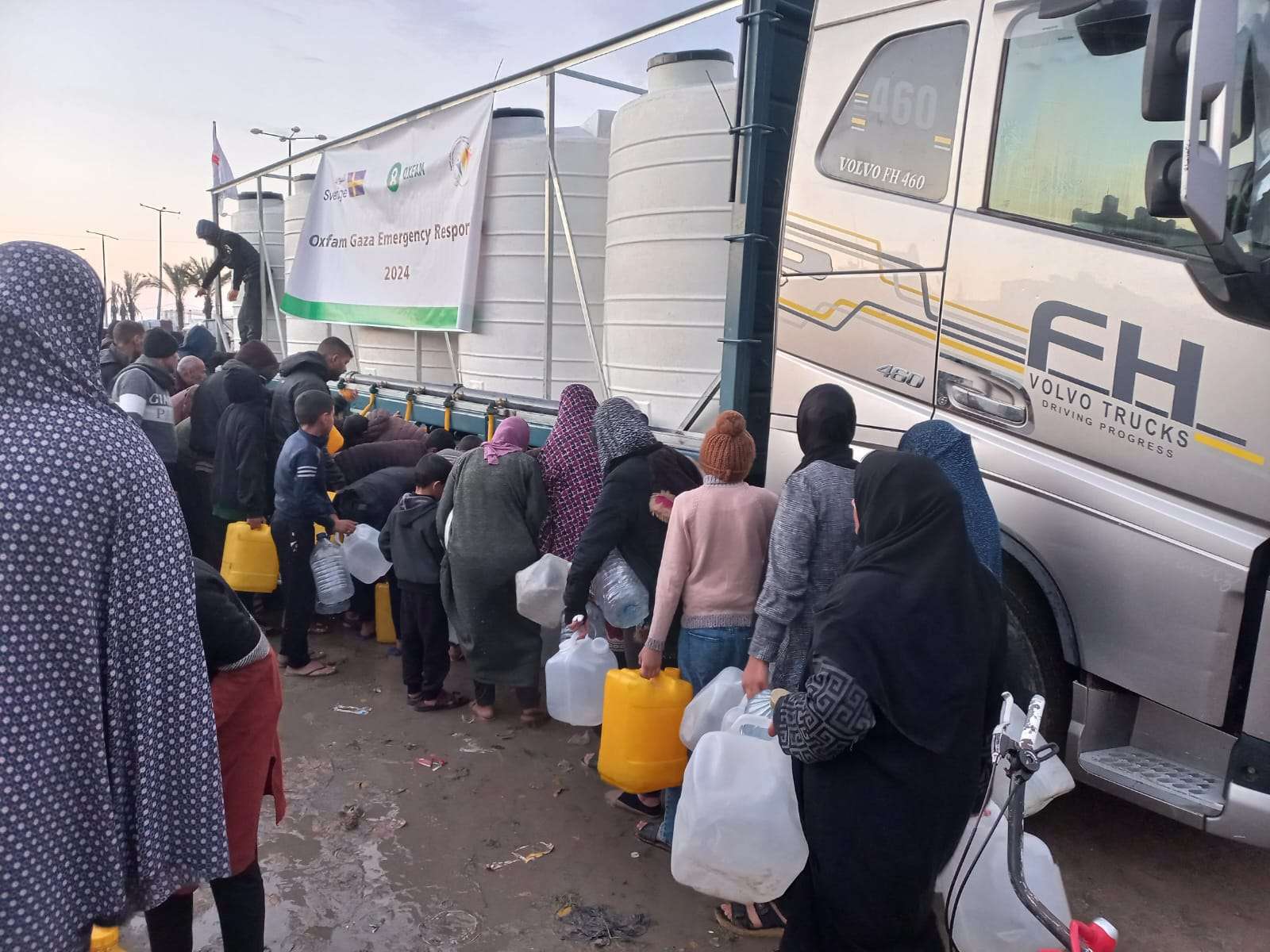 civilians in Gaza queue for water and food